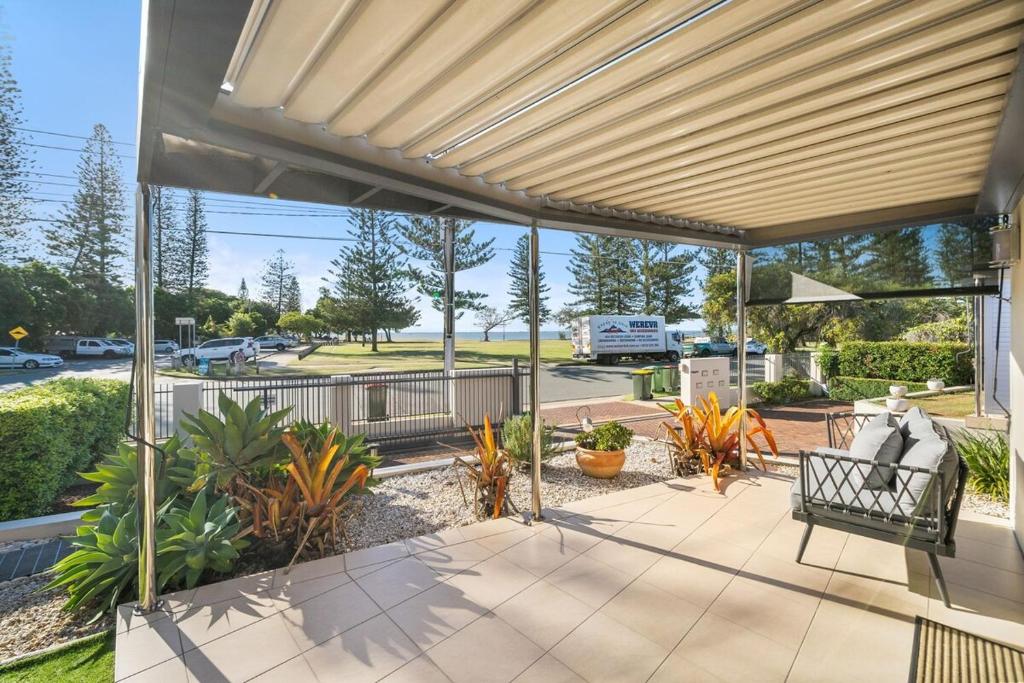 an outdoor patio with a bench and plants at Reef Point Retreat in Scarborough
