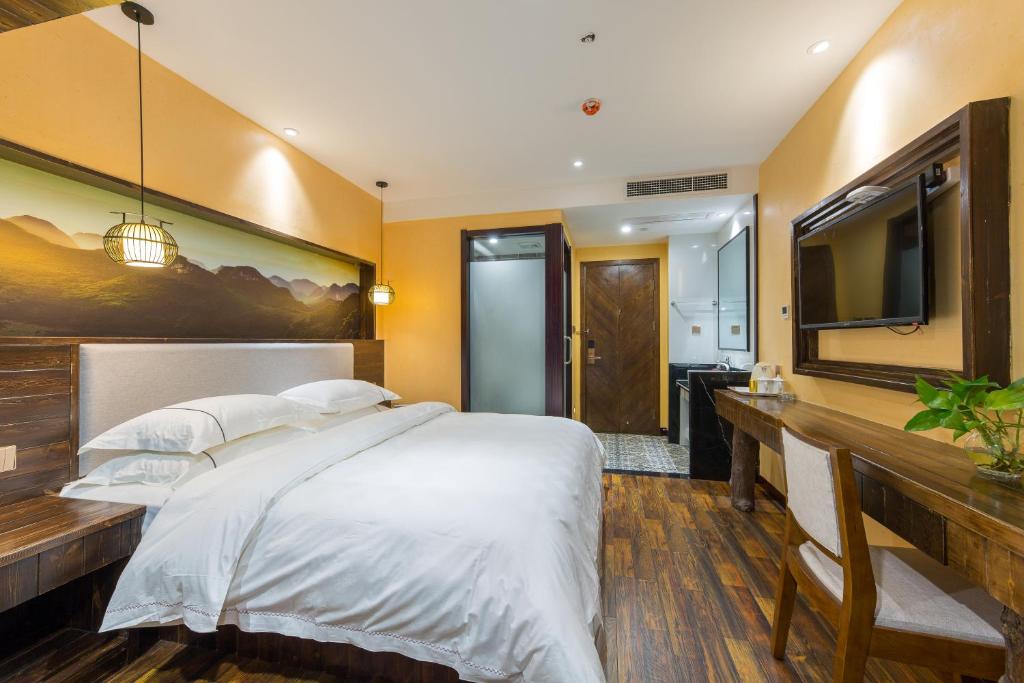 Postel nebo postele na pokoji v ubytování Yiwu Ruifeng Hotel