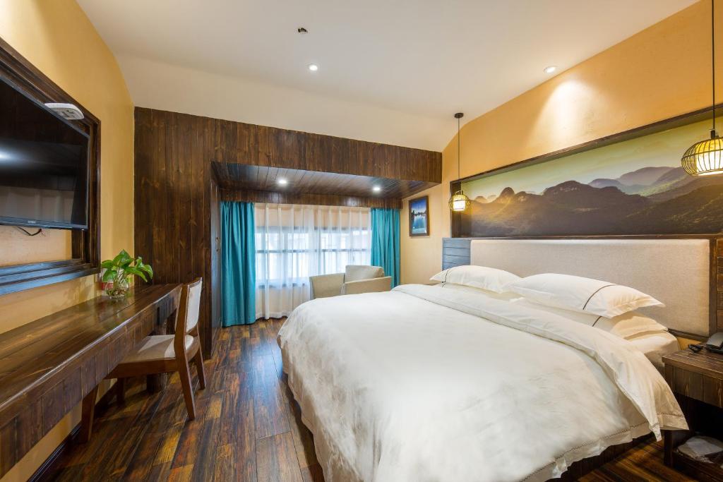 Postel nebo postele na pokoji v ubytování Yiwu Ruifeng Hotel