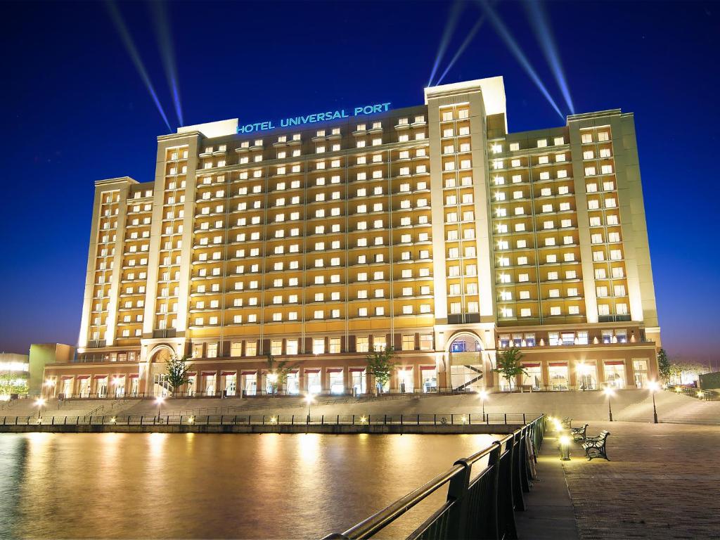 a large hotel building with a river in front of it at Hotel Universal Port in Osaka