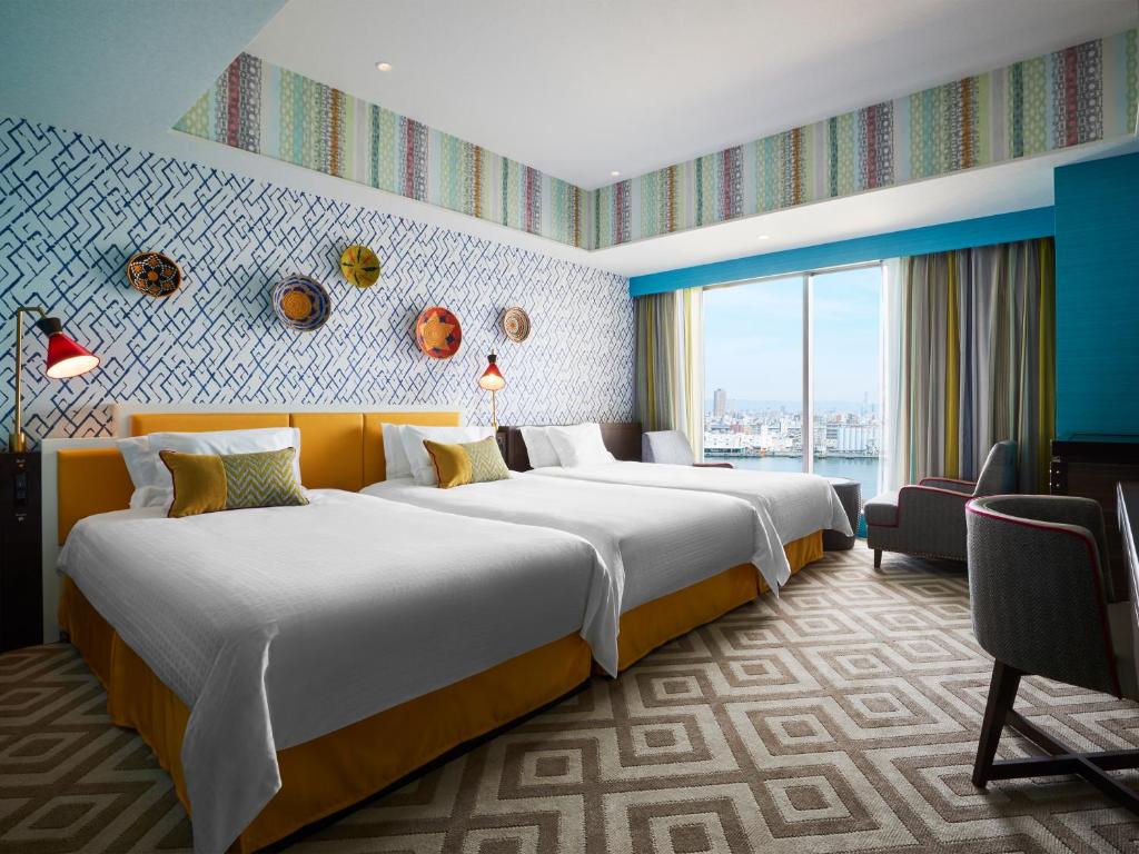a hotel room with two beds and a window at Hotel Universal Port in Osaka