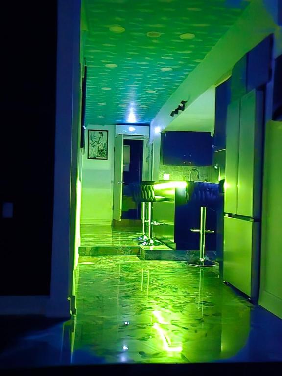 a room with a kitchen with green lights on the floor at The Georges Hidden Gem in Mount Vernon