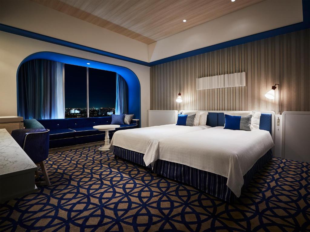 a hotel room with a large bed and a window at Hotel Universal Port in Osaka