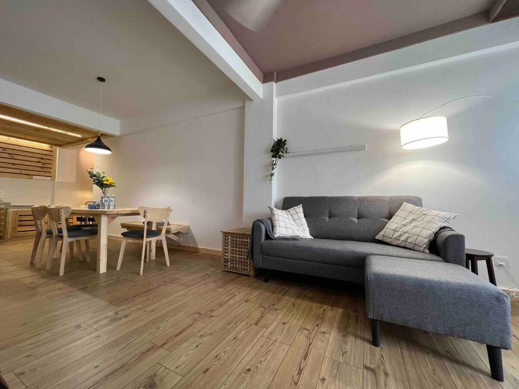 a living room with a couch and a table at Cosy Pinewood House 5 Pax- Family friendly, Wifi in Kajang