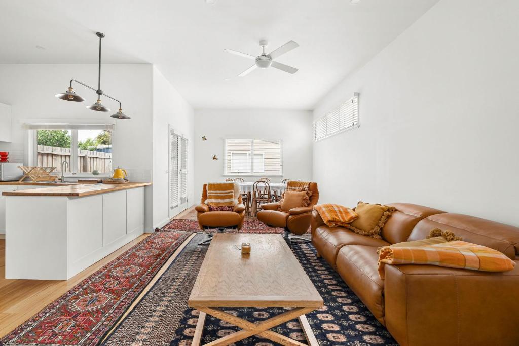 a living room with a couch and a table at Emu Nest at East Geelong in Thomson
