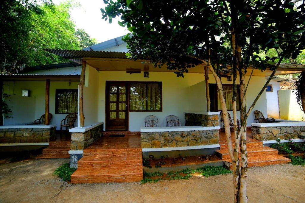 a house with a porch and stairs to it at Glenmore Resorts Munnar in Anachal