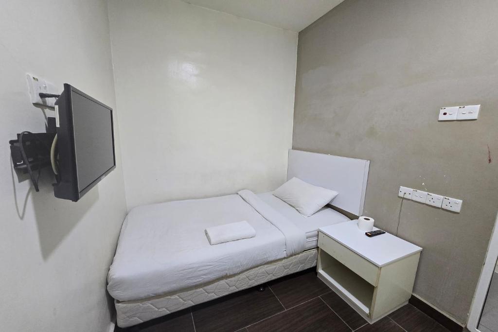 Postel nebo postele na pokoji v ubytování Fast Hotel Sri Gombak
