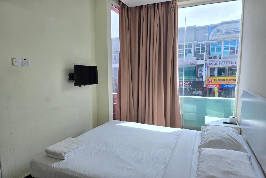 Postel nebo postele na pokoji v ubytování Fast Hotel Sri Gombak