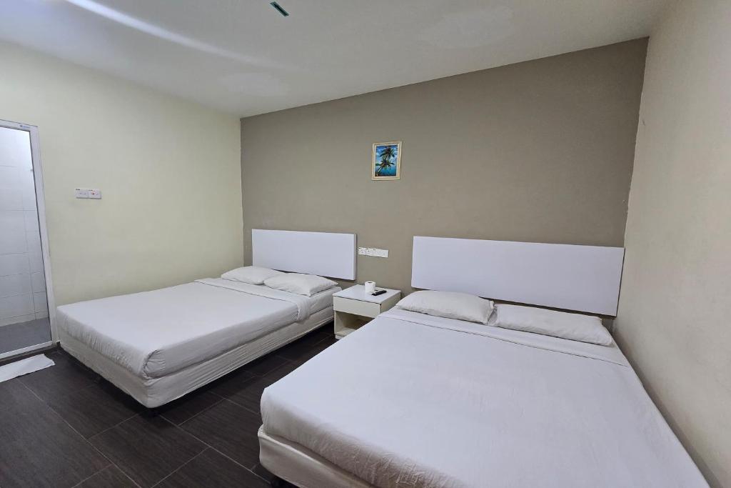 Postel nebo postele na pokoji v ubytování Fast Hotel Sri Gombak