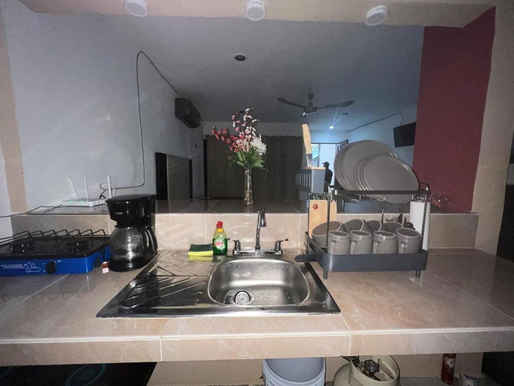 a kitchen counter with a sink in a kitchen at departamento sisal 1 in Valladolid