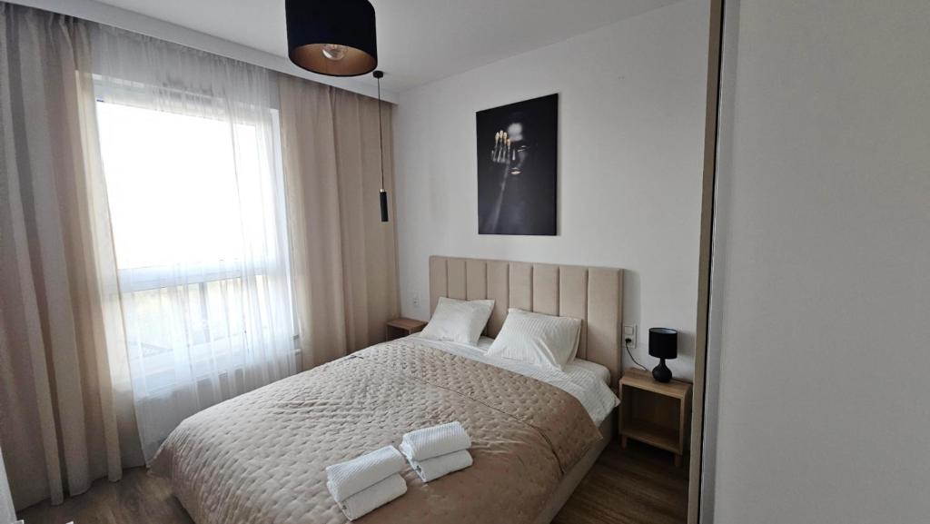 ein Schlafzimmer mit einem Bett mit zwei Handtüchern darauf in der Unterkunft Nova Letnica Sea Apartaments in Gdańsk Letnica