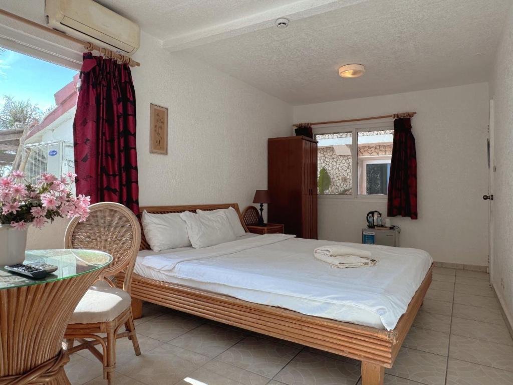 Postel nebo postele na pokoji v ubytování Sunset Beach Resort