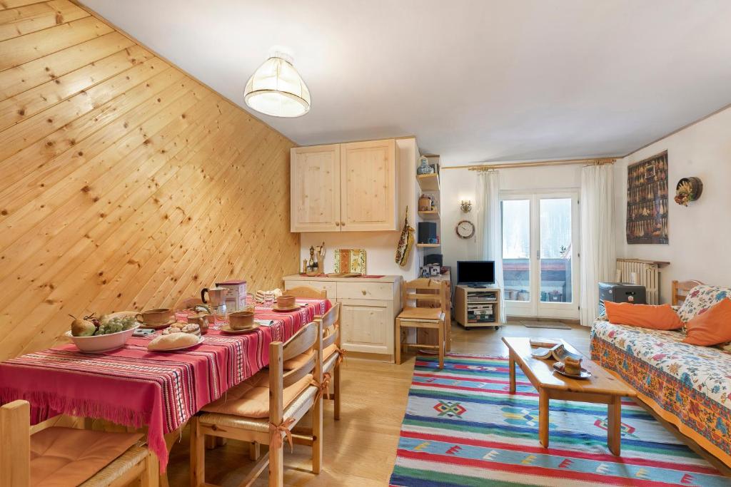 a living room with a table and a couch at Appartamento Quota 1800 - Happy Rentals in Claviere