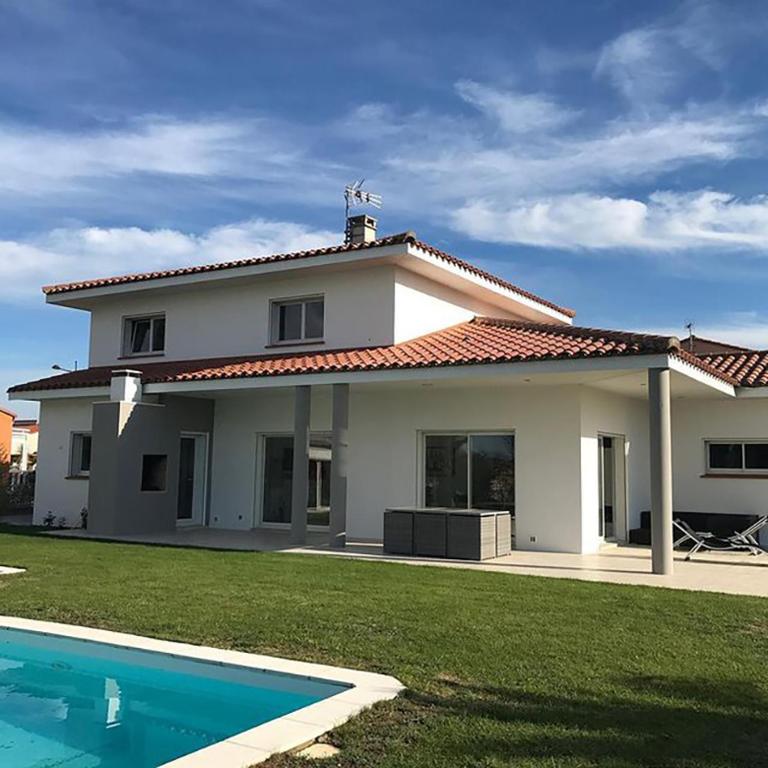 une grande maison blanche avec une piscine en face de celle-ci dans l'établissement Villa d'exception à louer pour vos vacances, à Pollestres