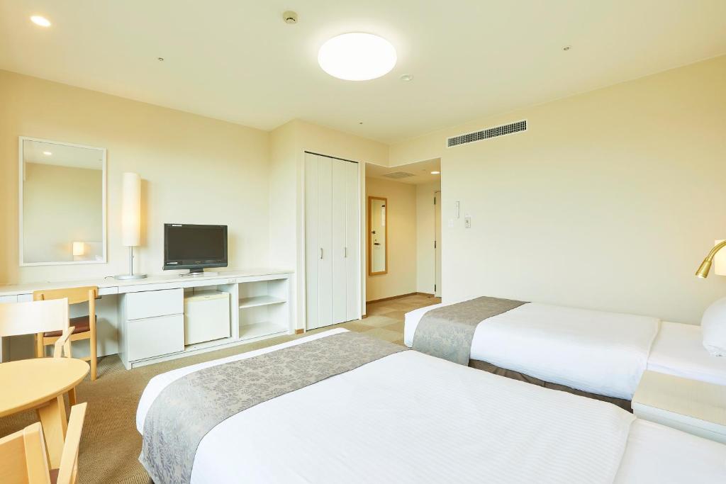 Postel nebo postele na pokoji v ubytování KAMENOI HOTEL Fukui