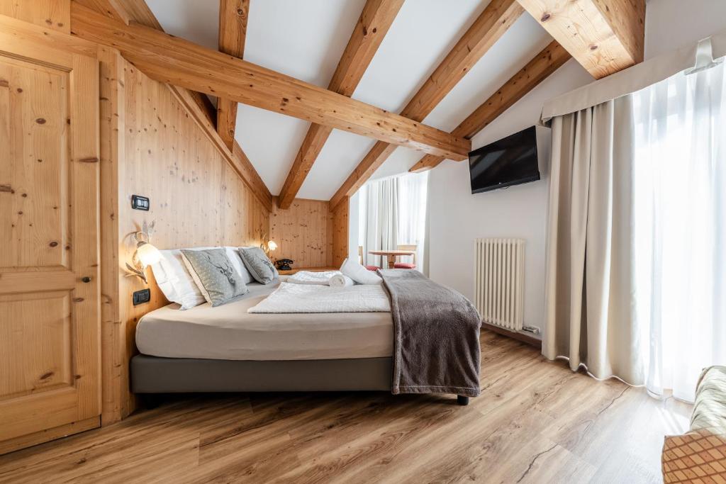 Postel nebo postele na pokoji v ubytování Hotel Sasso Rosso