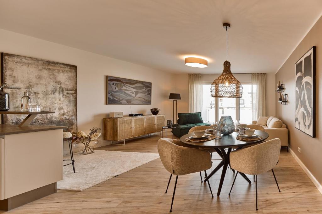 a kitchen and living room with a table and chairs at Seeloft - Boutique Apartments Am See in Fulda
