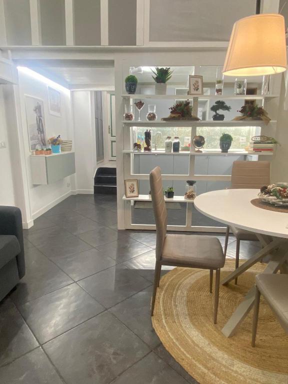 a living room with a table and a dining room at Loft Torlonia in Rome