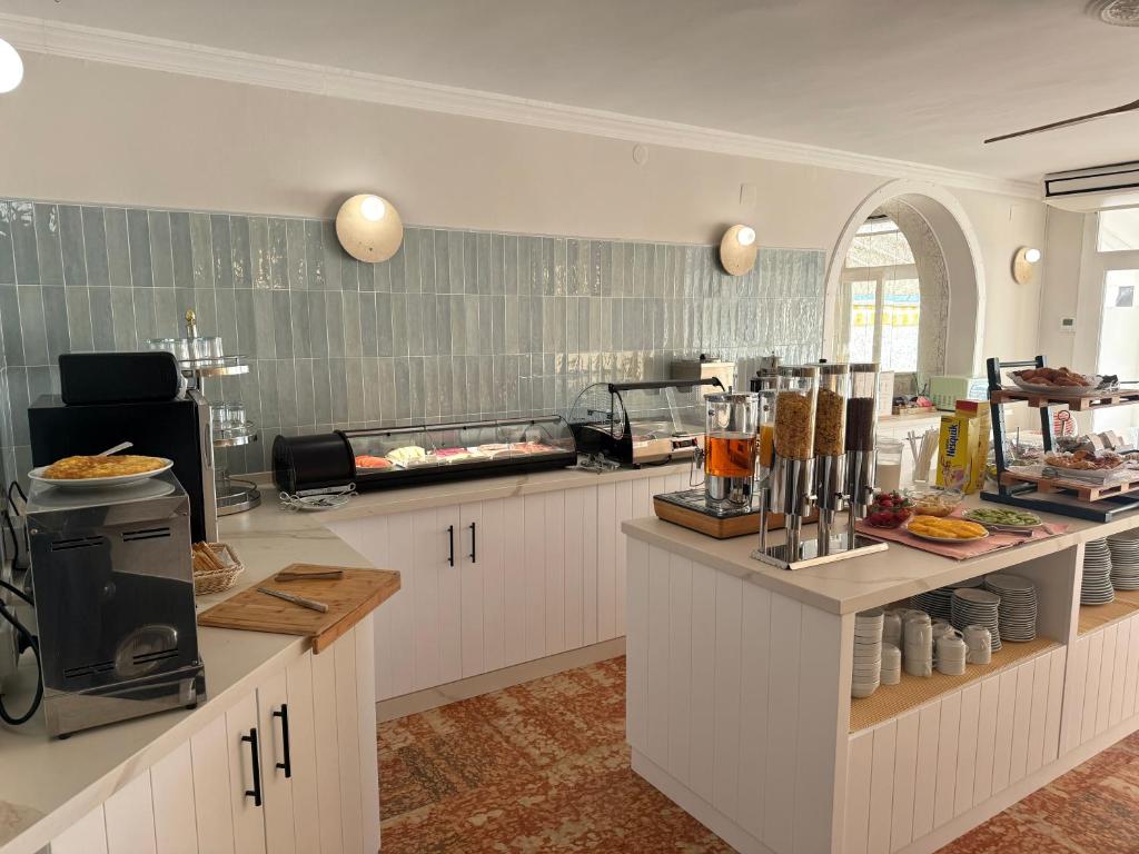 a kitchen with a counter with food on it at Hotel Paraíso Del Mar in Nerja