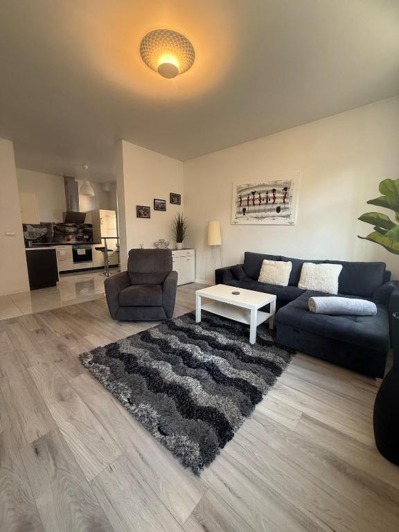 a living room with a couch and a table at I'M Apartment SILVER I centrum free parking in Bolesławiec