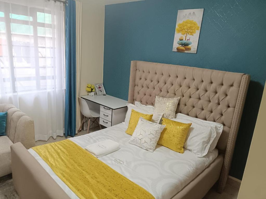 Postel nebo postele na pokoji v ubytování Cavendish Square Apartments Syokimau