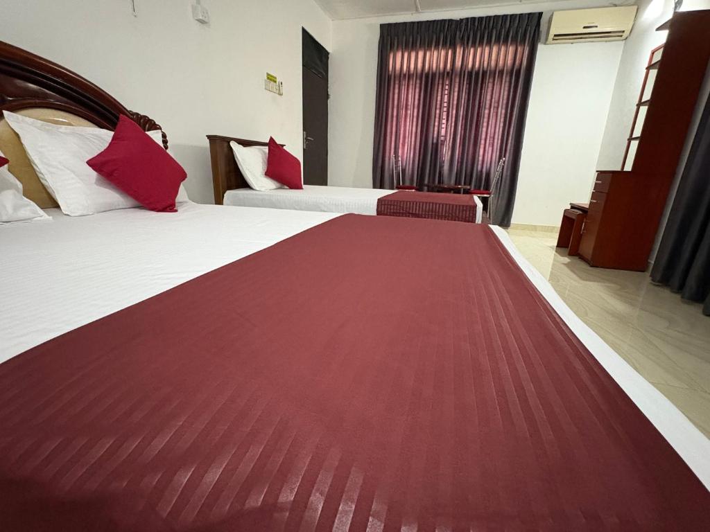 Postel nebo postele na pokoji v ubytování Dee Ella Hotel