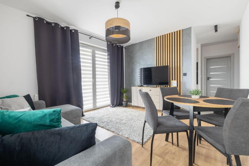 a living room with a couch and a table at VIP APARTAMENTY Lubelska in Rzeszów