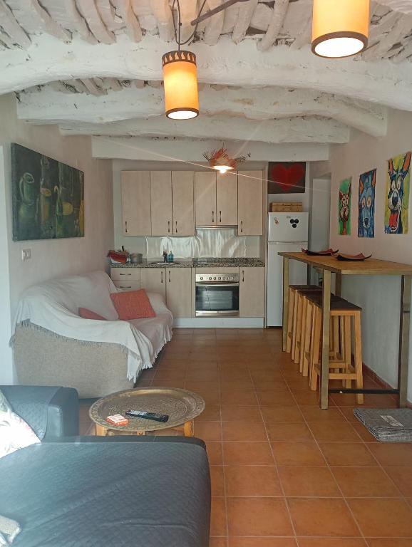 a living room with a bed and a kitchen at Casa Manuela in Busquístar