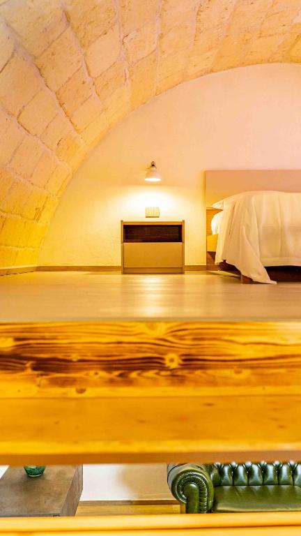 A bed or beds in a room at Il Melograno - Suite Deluxe