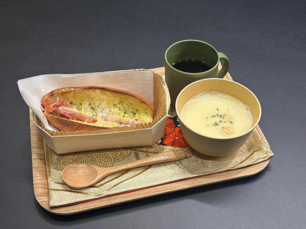 a tray with a sandwich and a cup of soup at Minn Nijo-jo in Kyoto