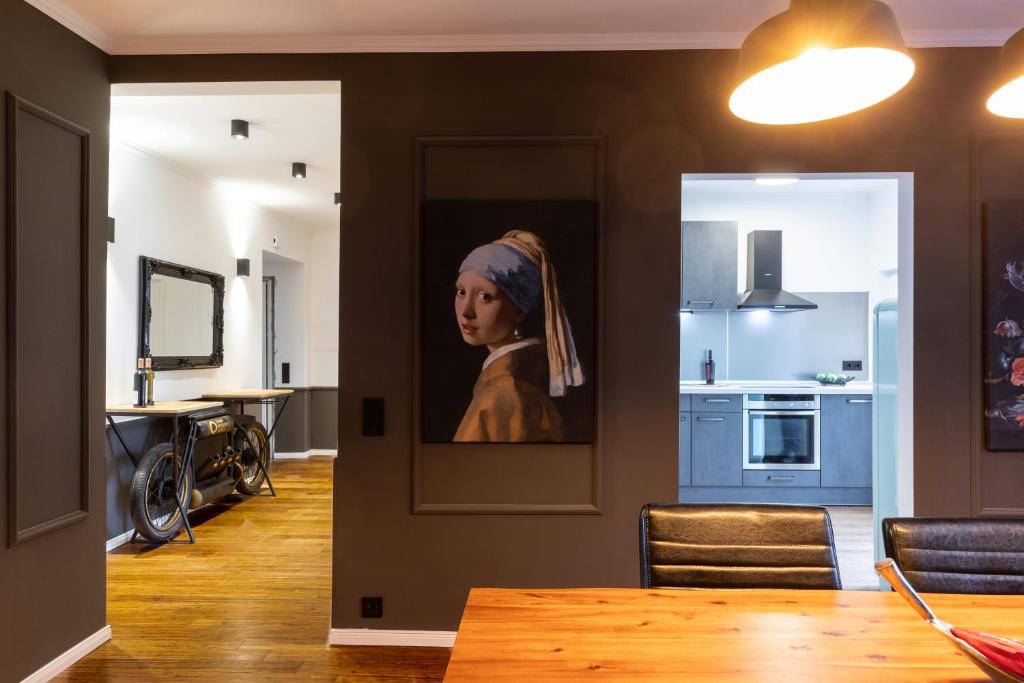 a painting of a girl on a wall in a kitchen at Mokka Suite Design in Neumünster in Neumünster