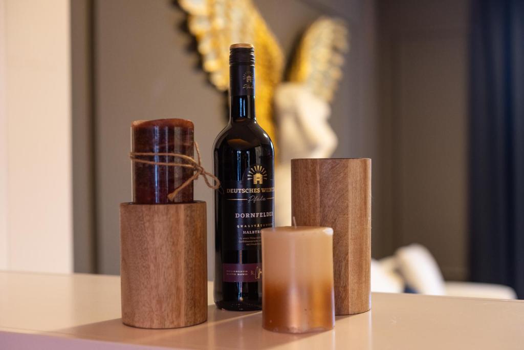 a bottle of wine sitting on top of a table at Mokka Suite Design in Neumünster in Neumünster