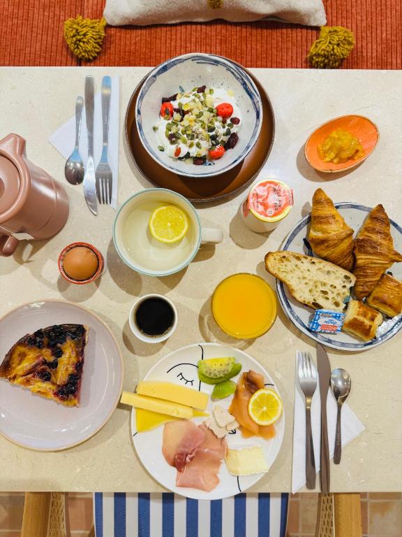 a table with plates of food on it at Hôtel Gabriel in Menton