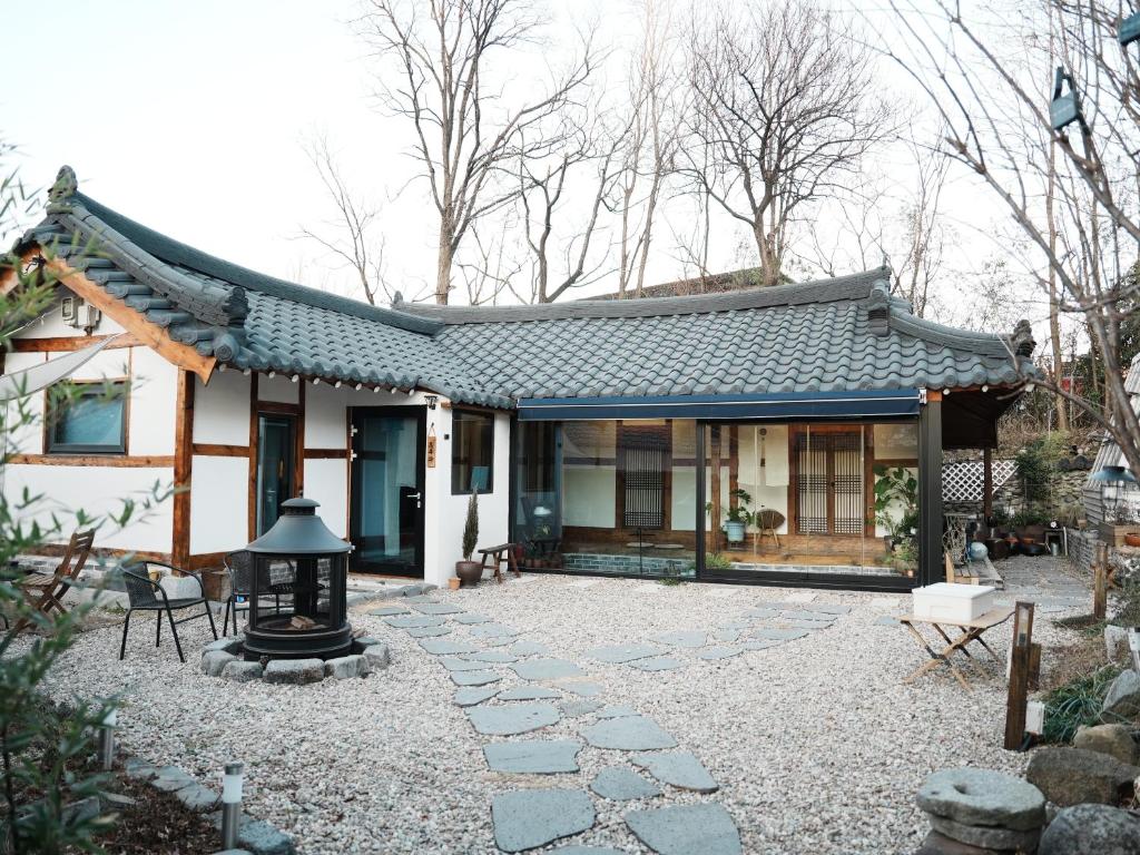 a small house with a shingle roof at Bow Hanok House in Gangneung