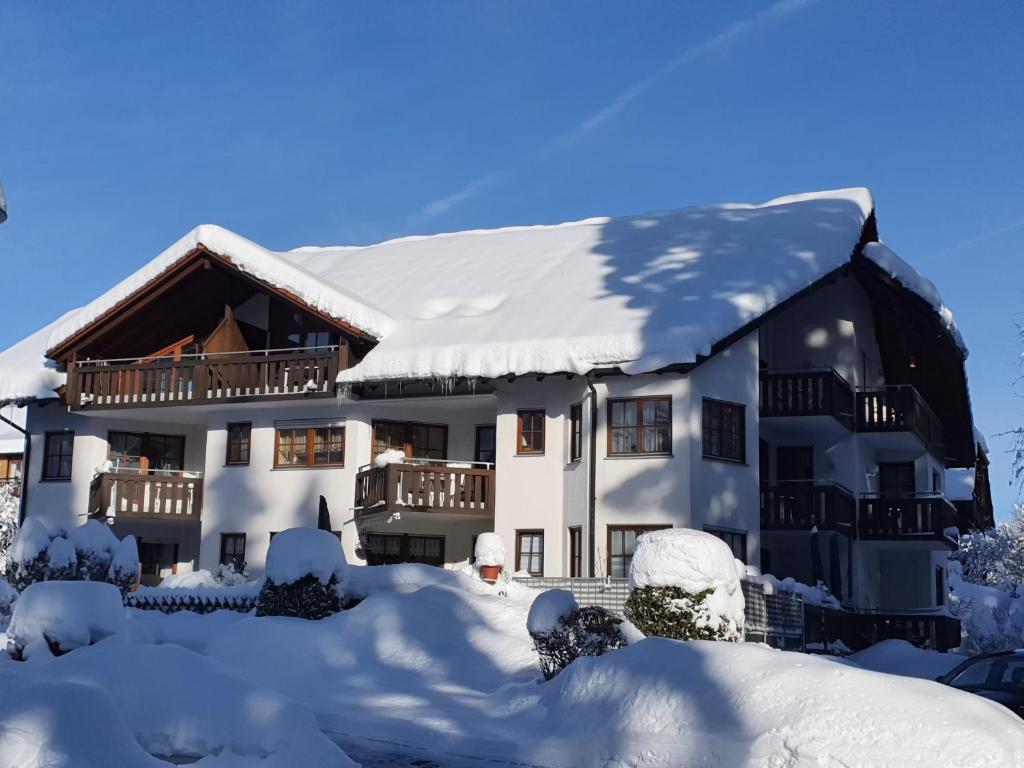 a house covered in snow with snow at Haus an der Gutach in Titisee-Neustadt