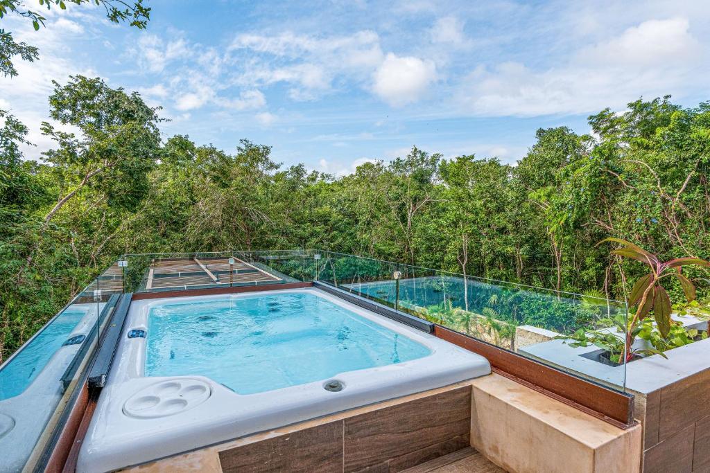 a swimming pool on top of a house with trees at Casa Jaguar Villa 2 in Xpu Ha