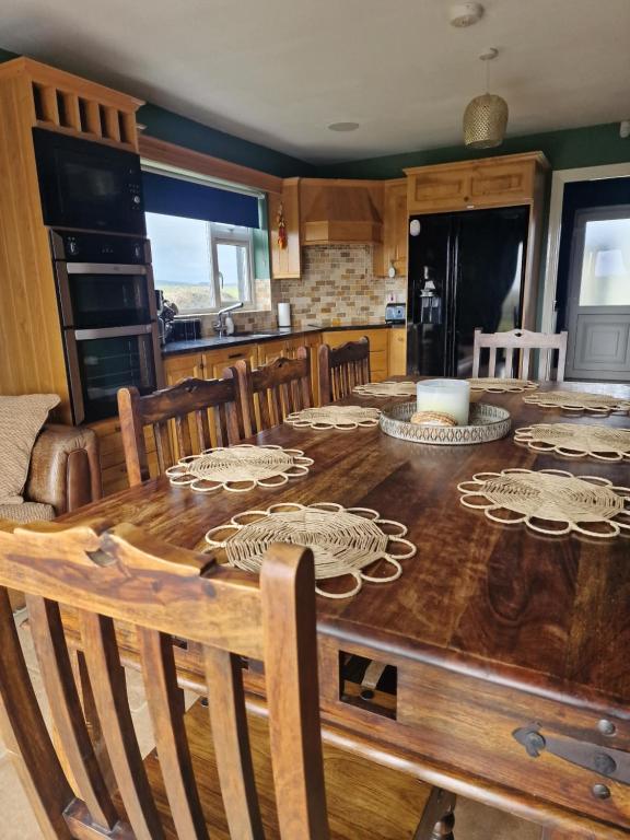a kitchen with a wooden table with plates on it at Shanadune in Tralee