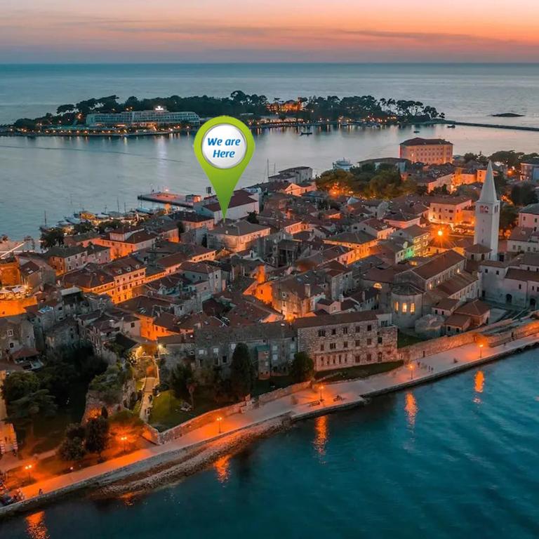 a hot air balloon flying over a city at night at San Eleuterio Guesthouse in Poreč