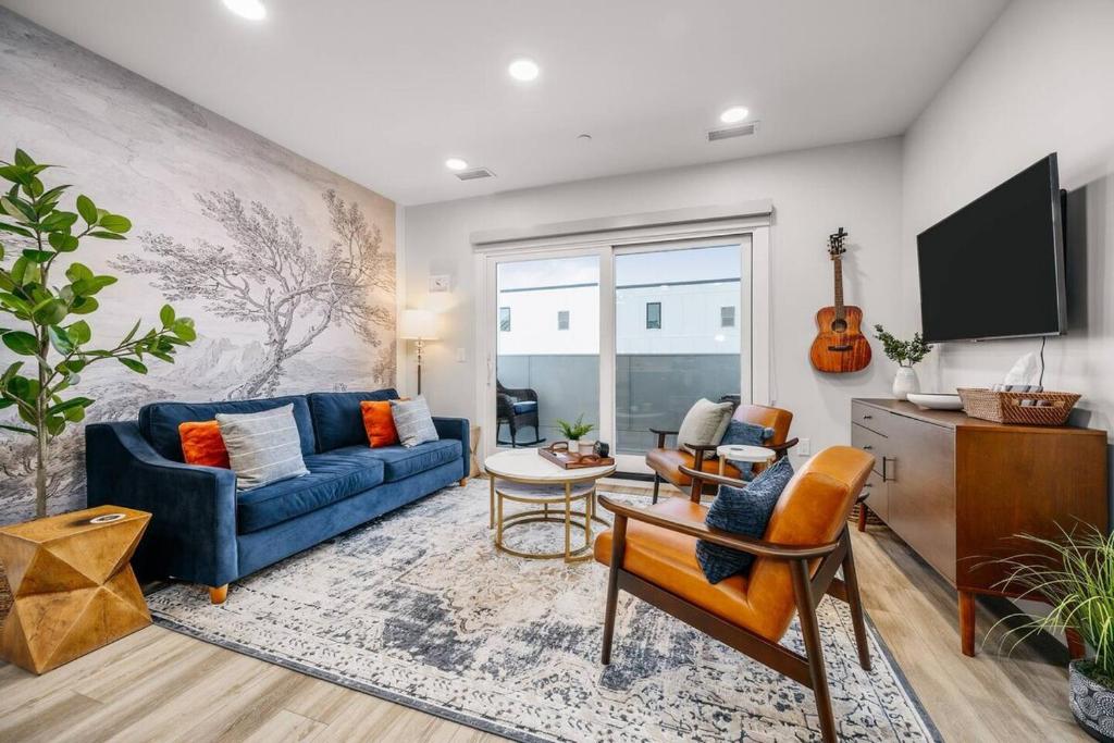 a living room with a blue couch and a tv at Jude's Respite in Traverse City