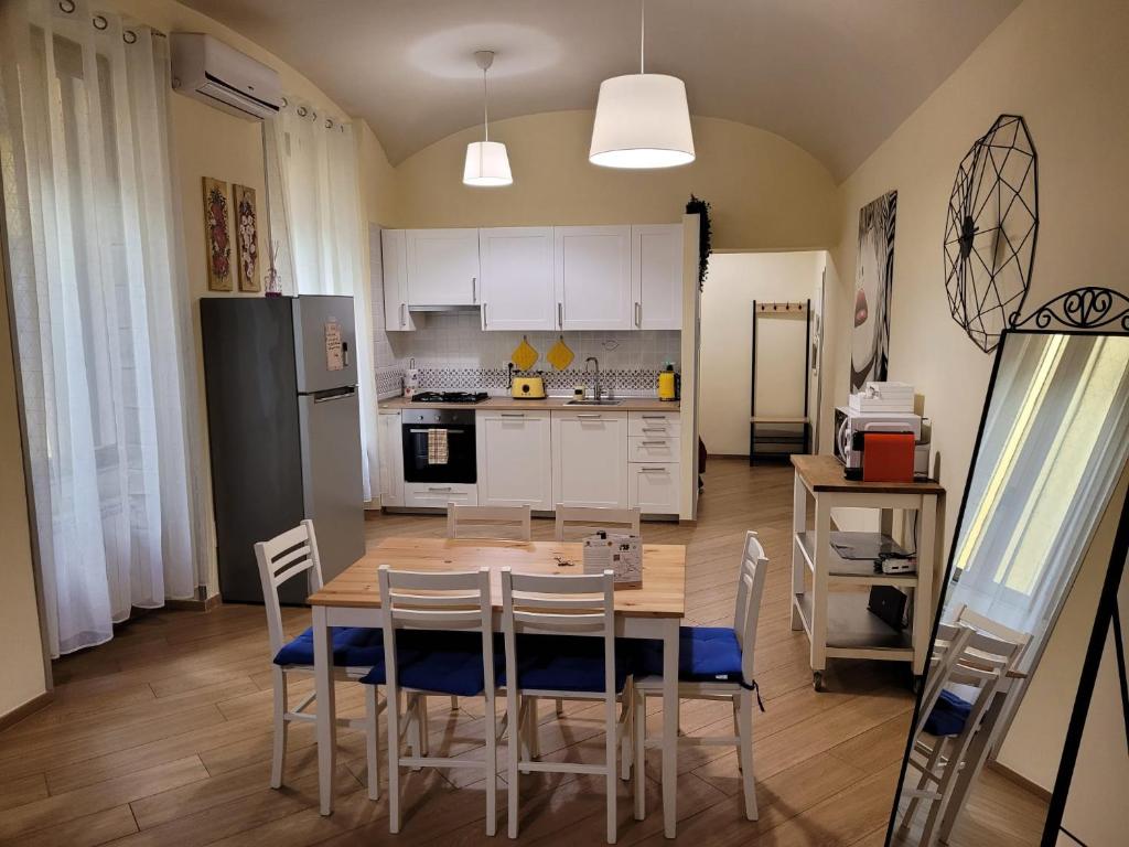a kitchen with a table and chairs and a refrigerator at Home Vaticano 50 steps from Museum in Rome