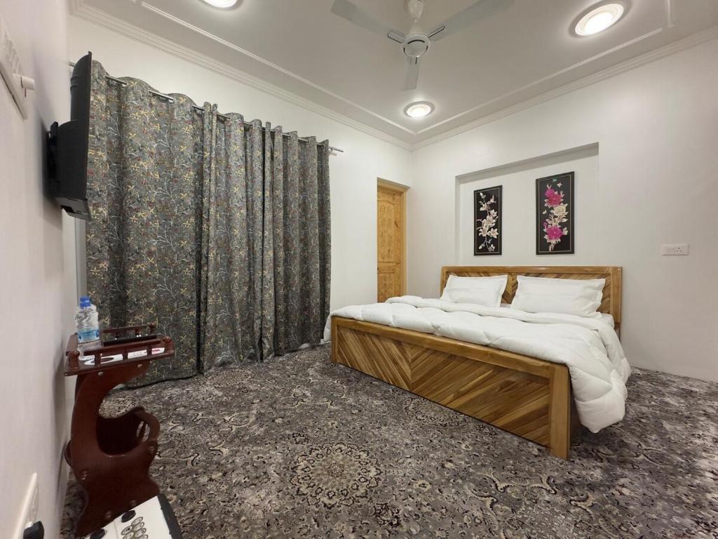 a bedroom with a bed and a flat screen tv at Dream Stays in Nārachpur