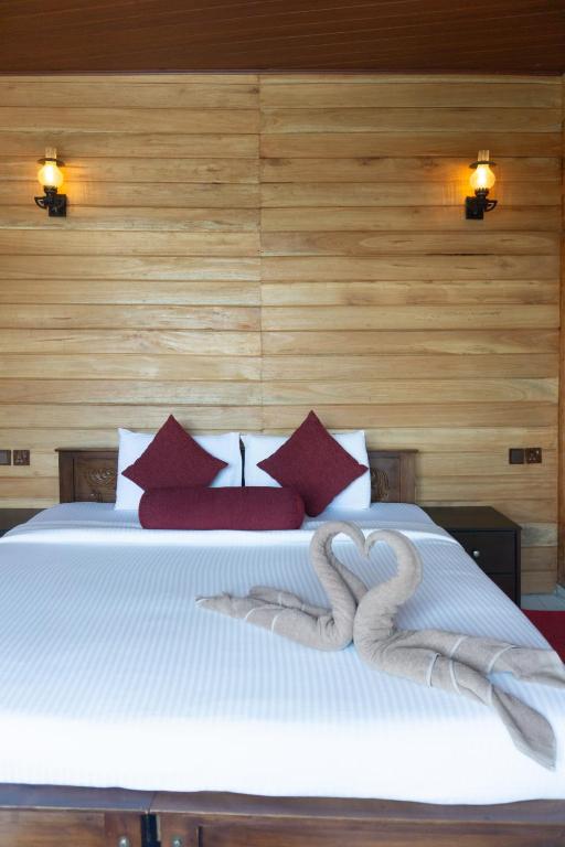 Postel nebo postele na pokoji v ubytování Refresh Inn Ella
