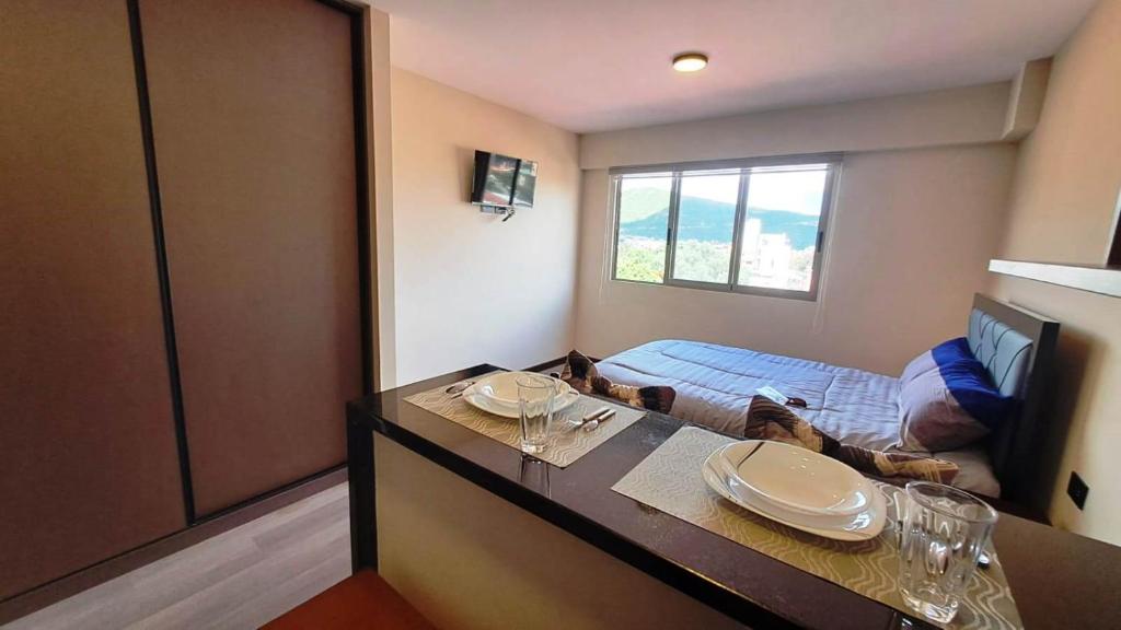 ein Zimmer mit einem Tisch und einem Bett darin in der Unterkunft Marmor Homes in Cochabamba