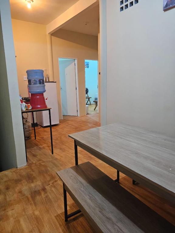 een woonkamer met een tafel en een kamer met een keuken bij Casa Mandacaru in Ubajara