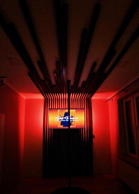 a light in a room with a red wall at Dark Romance- Apartament BDSM Greya dla Zakochanych Par in Ruda Śląska