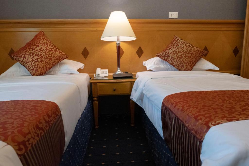 Postel nebo postele na pokoji v ubytování فندق المروج كريم AlMorooj Kareem Hotel