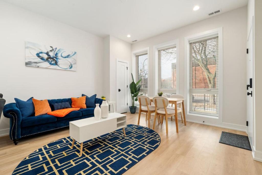 a living room with a blue couch and a table at Gilean Urban Retreat in Chicago