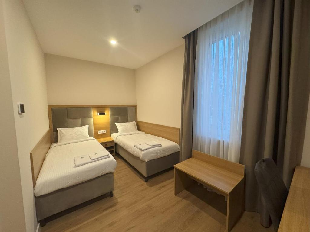 Postel nebo postele na pokoji v ubytování Promenaden Hotel