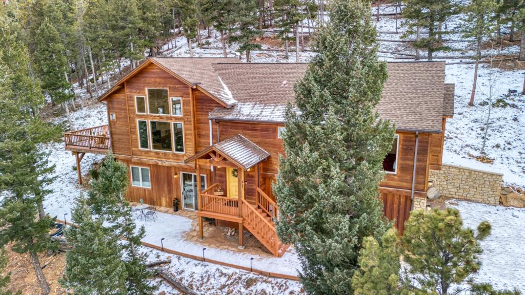 an aerial view of a log home in the snow at BEST VIEWS! Luxury Mountain Home - Saltwater HotTub, Firepit, BBQ- Close to Trails, Red Rocks in Evergreen