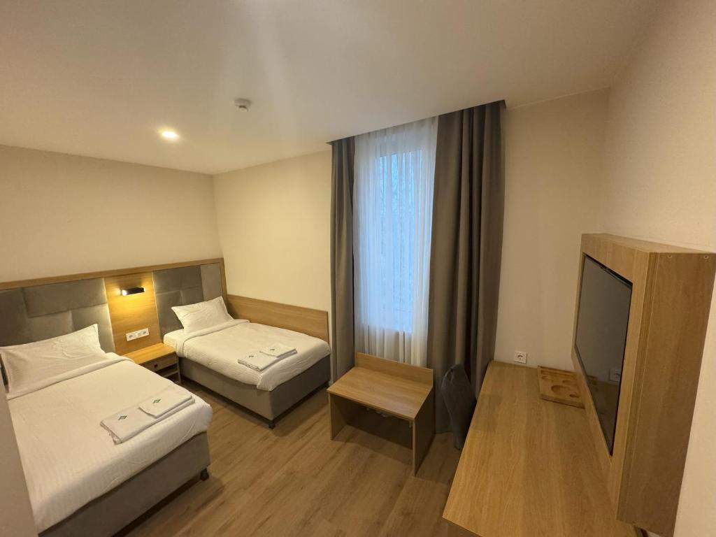 Postel nebo postele na pokoji v ubytování Promenaden Hotel